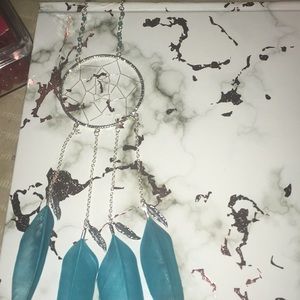 A dream catcher necklace with feathers